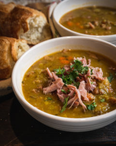 Split pea soup with ham in a white bowl