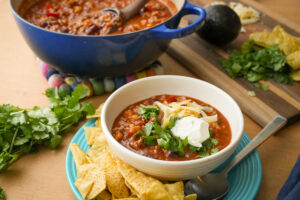 White bowl of taco soup made with Hempler's pork.