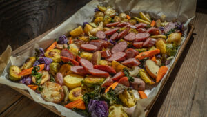 Sheet pan dinner with sausage, Brussel sprouts, onions and carrots.