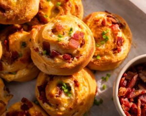 Pastry pinwheels are filled with cheddar cheese and bacon crumbles.